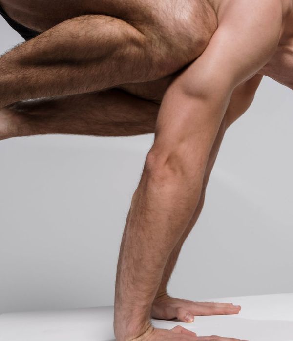 Focused man doing a core stability exercise on a mat.